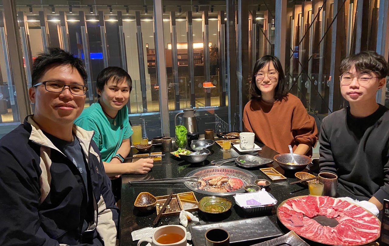 Laboratory members celebrating a paper acceptance over dinner